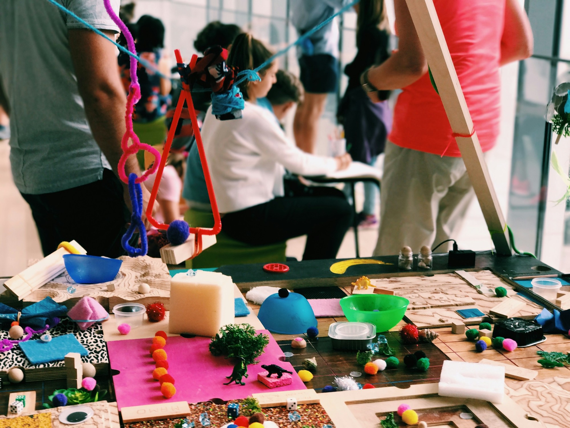 Community members gathered around a creative workshop table
