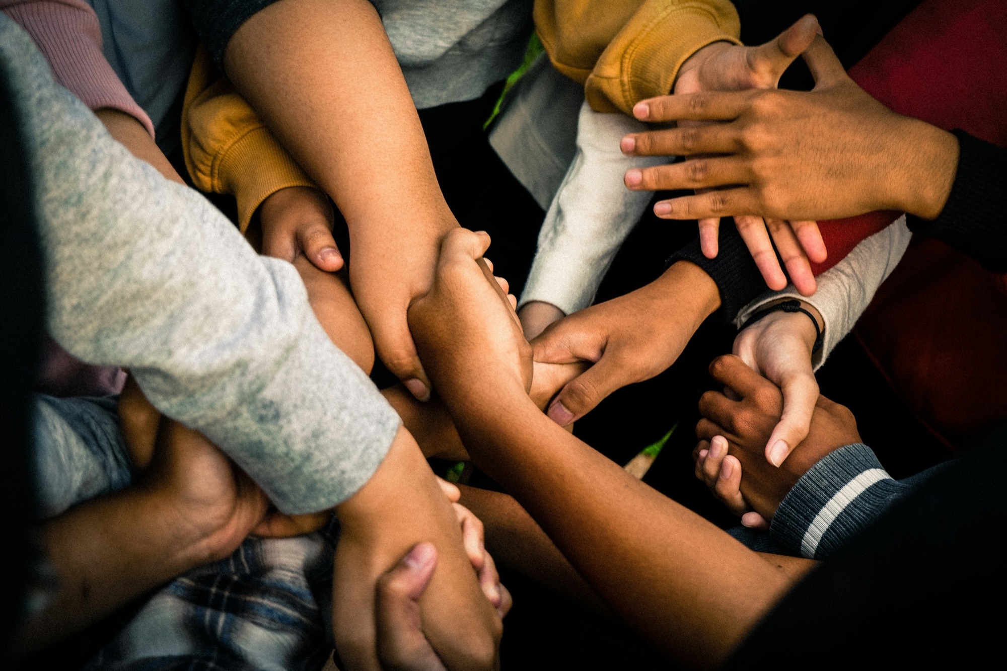 Many hands joined together in unity